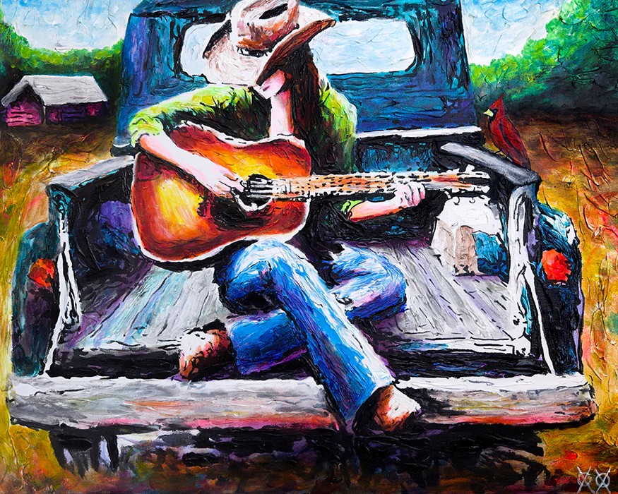 Výrazne farebný obraz. Záber na auto s vlečkou, na ktorej sedí dievčina s dlhými čiernymi vlasmi v kovbojskom klobúku a v rifliach. V rukách drží gitaru, na ktorej hrá. Auto ide po poľnej ceste, v pozadí vidieť malý dom a zeleň. 